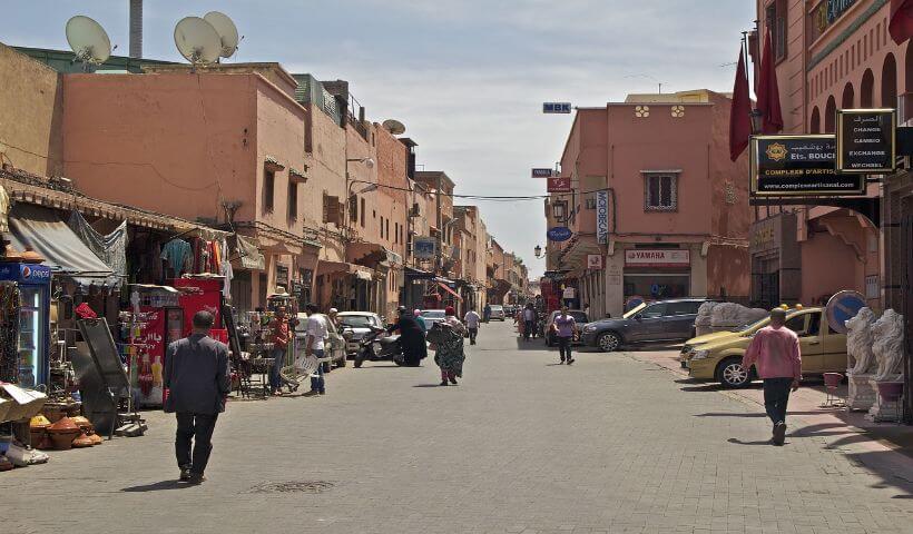 Eine Seitenstraße von Marrakesch mit einigen Läden und Menschen die unterwegs sind