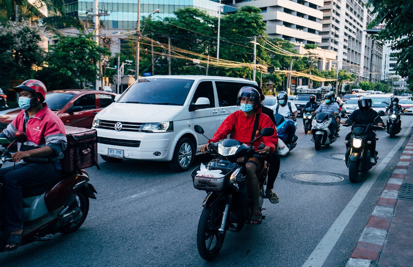Autos und Roller auf Bangkoks Straßen.